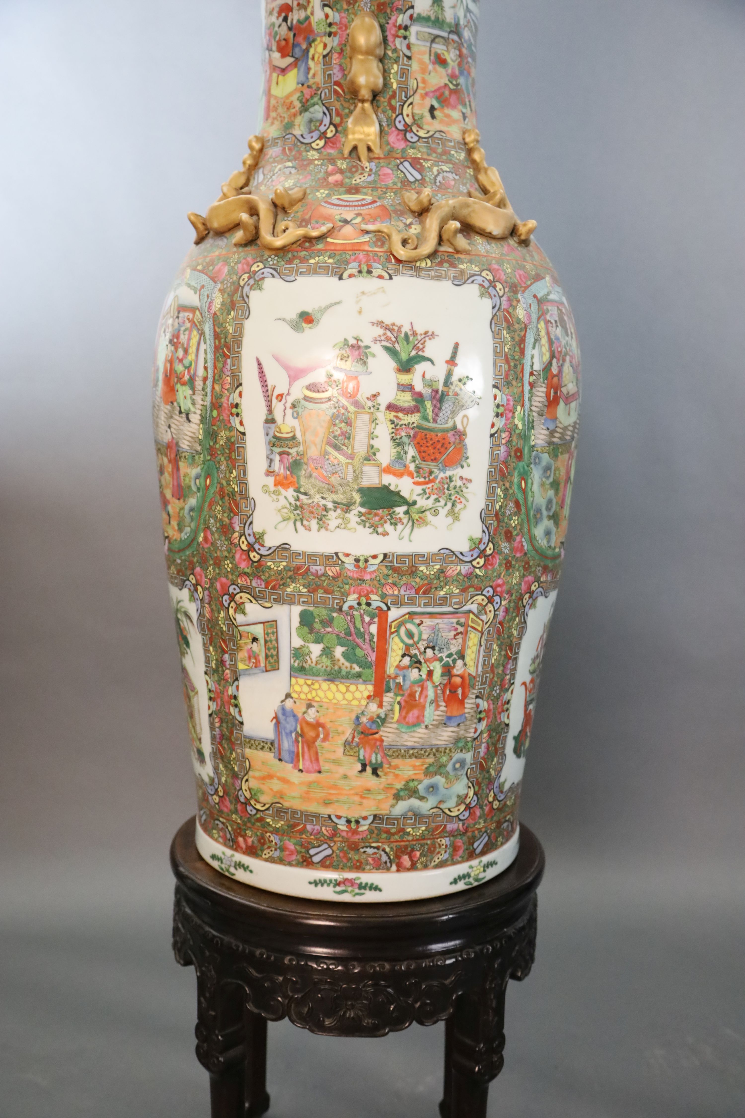 A pair of massive Chinese Canton style famille rose vases, 20th century and a pair of Chinese hongmu and marble stands, late 19th century